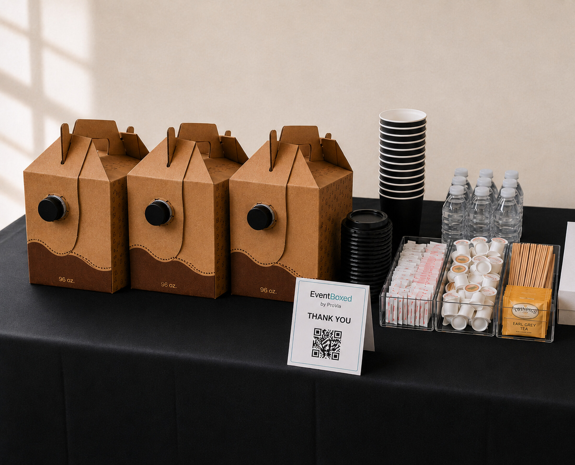 EventBoxed coffee station with travellers, cups, and condiments on a meeting table